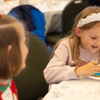 Little girl touching her decorated cookie